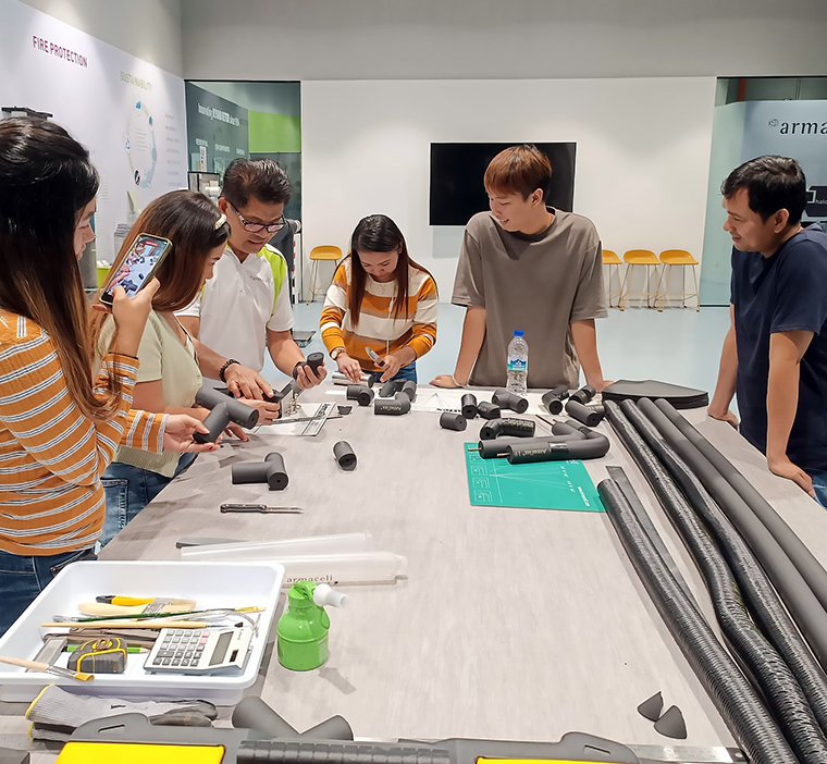 Participants of Hi!ArmaLive learning how to install ArmaFlex insulation material at ArmaLive Experience Centre in Singapore